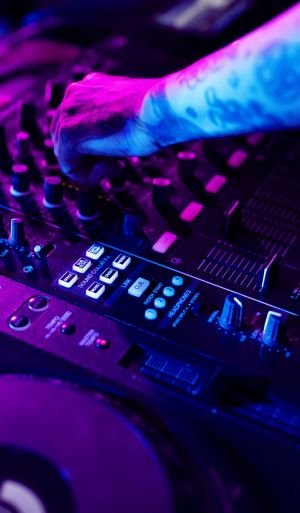 Hand on a sound mixer station Hand on a sound mixer station